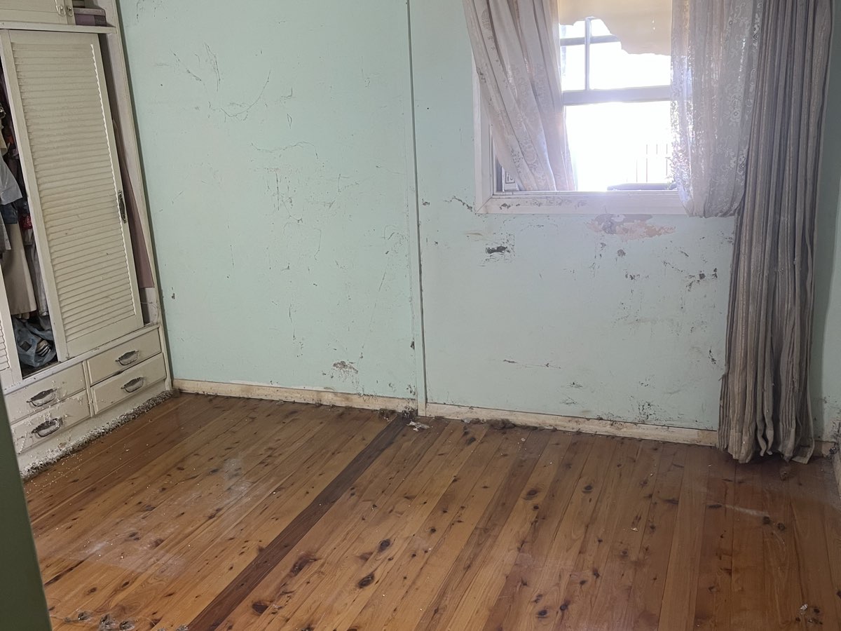 The same bedroom cleared back to the floorboards after the job