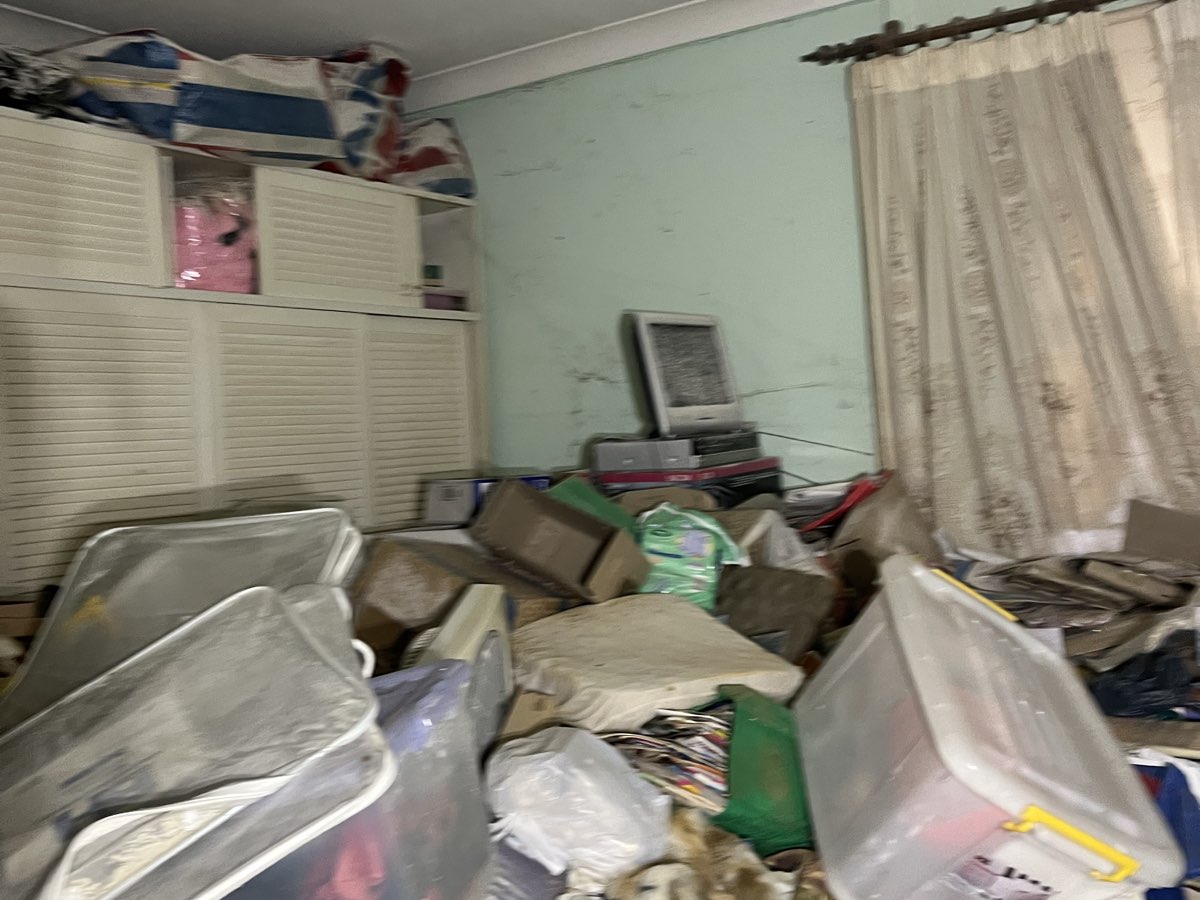A hoarded bedroom before a Hoarder Cleanup clearance, a real job